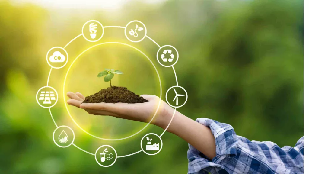 Hand holding a seedling against a green background, representing sustainability