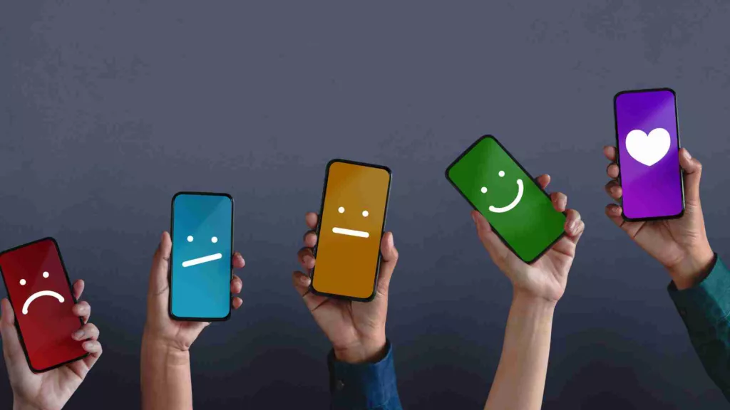 Phones with different emojis, representing different levels of customer satisfaction
