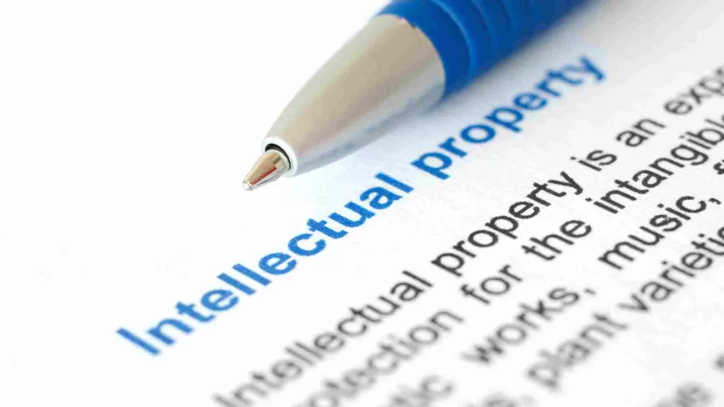 Snapshot of a pen with a book and part of a definition of Intellectual Property