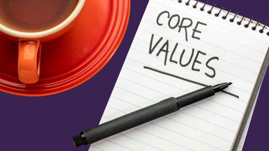 Cup of coffee alongside a notepad, with the words 'core values' written on it