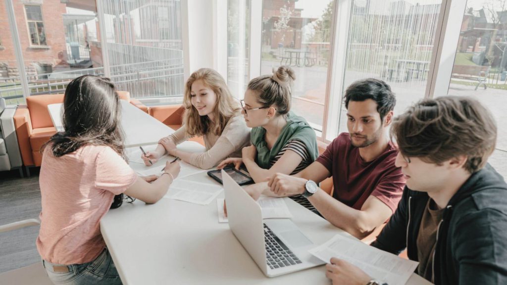 Graduate employees at work around a meeting table