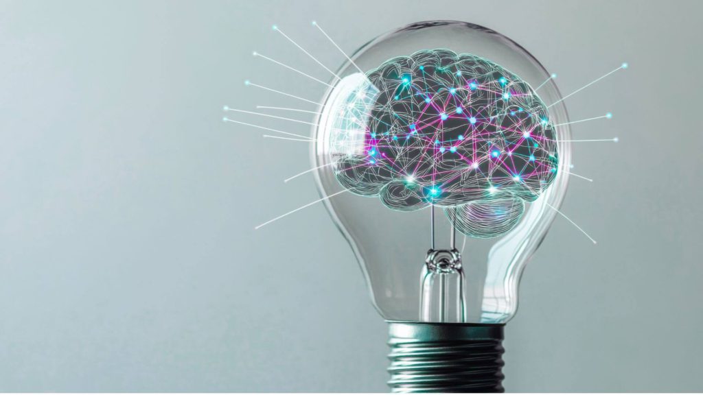 Illustration of a brain inside a lightbulb, representing innovation mindset