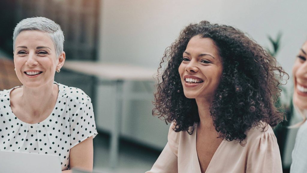 Female business leaders smiling in a meeting