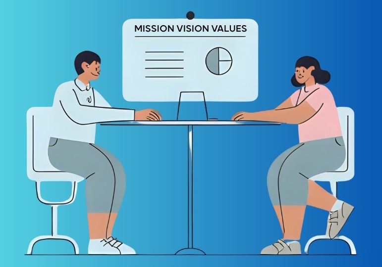 2 people sitting across a table, looking at a chart